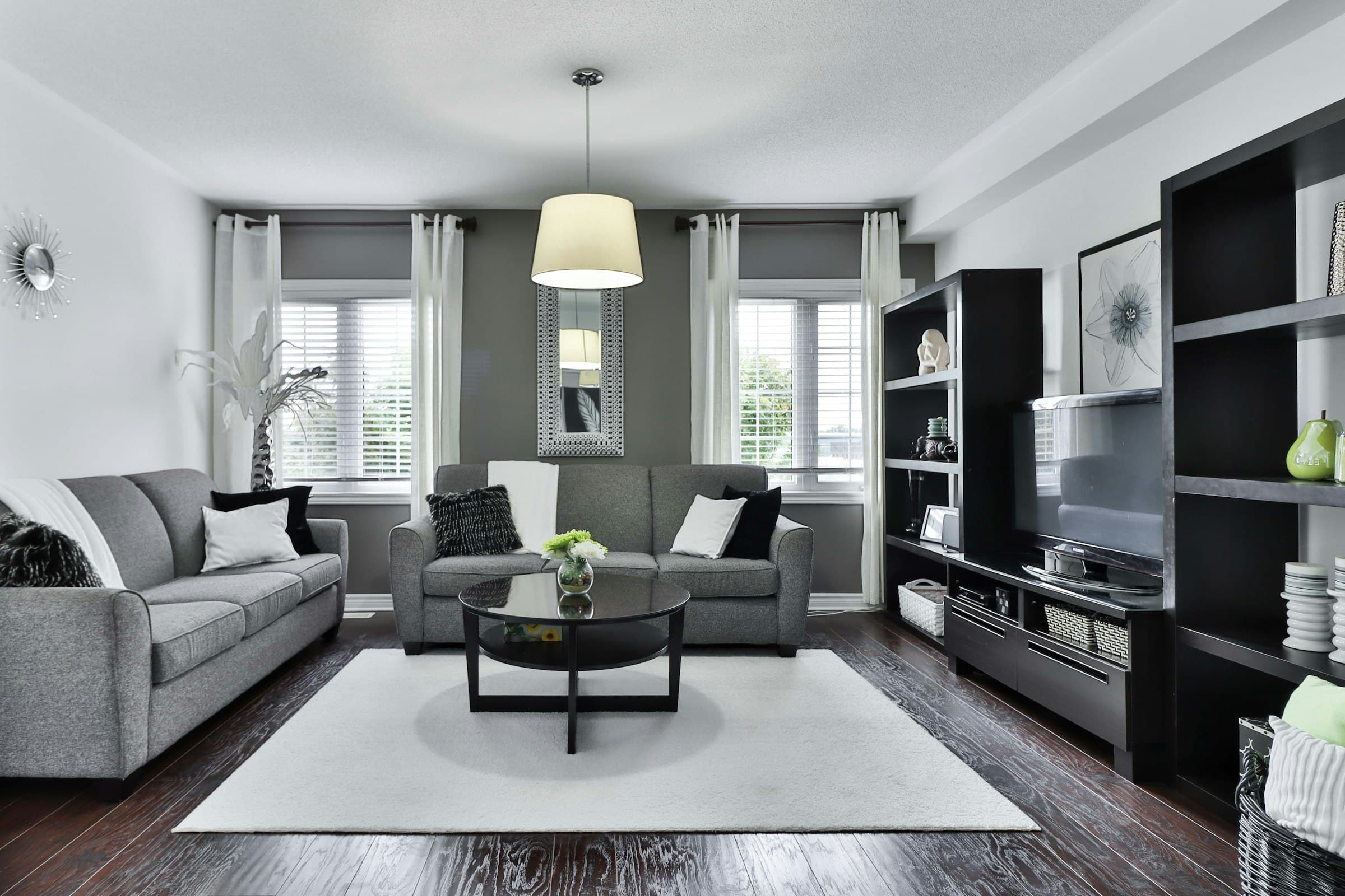 Dark media wall with integrated television, joinery and concealed lighting